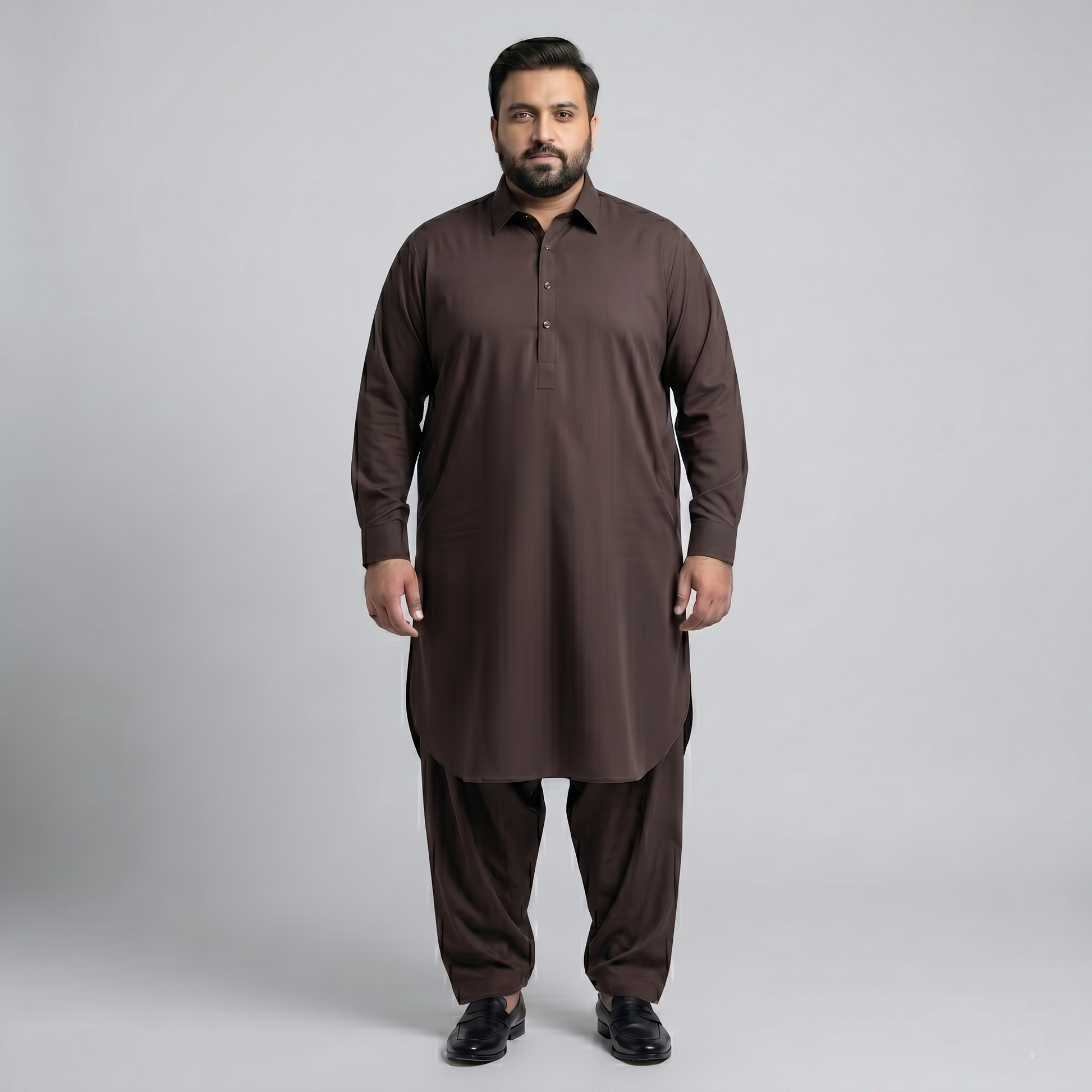 Man wearing a brown traditional outfit on a gray background