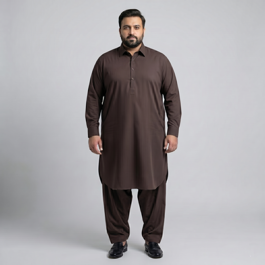 Man wearing a brown traditional outfit on a gray background