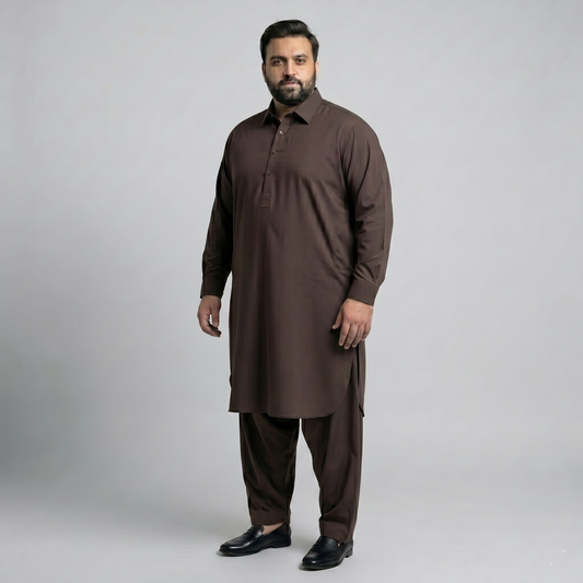 Man wearing a brown traditional outfit on a gray background