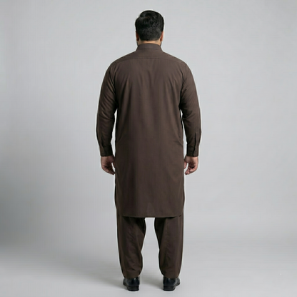 Man wearing a brown traditional outfit on a gray background