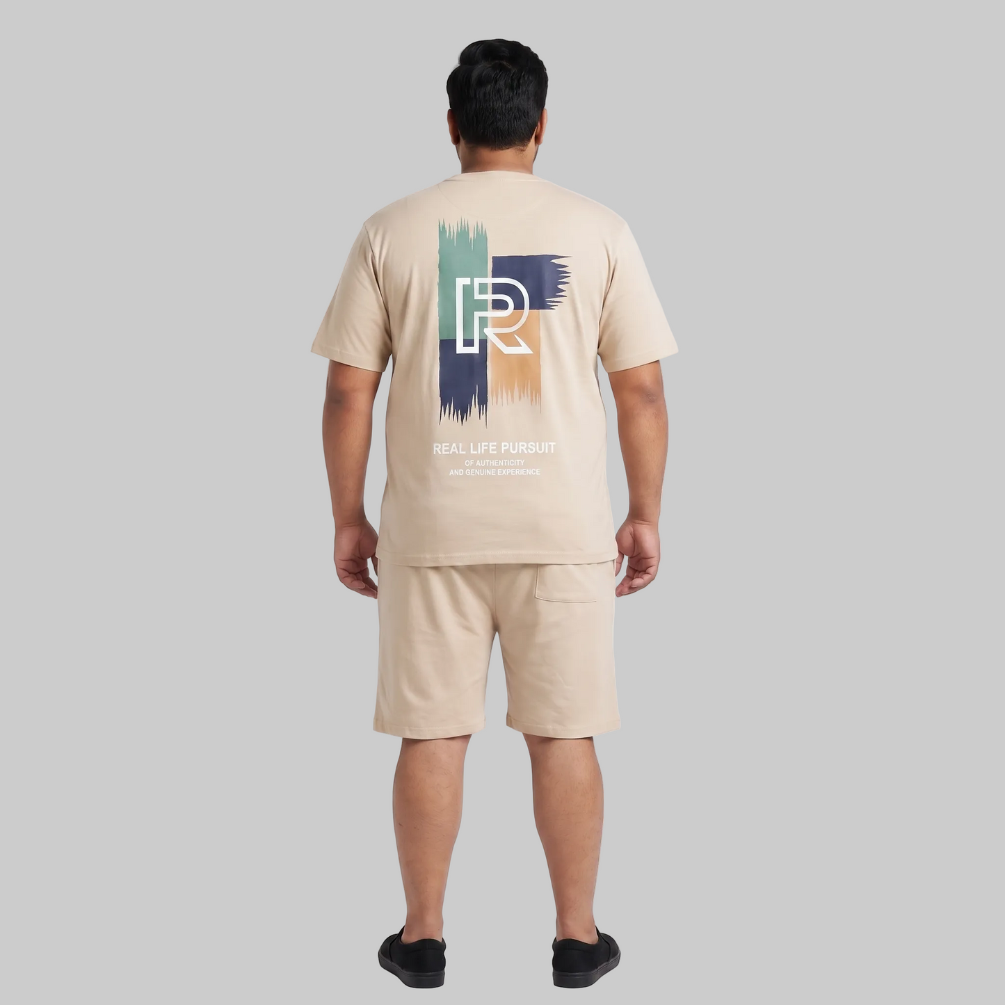 Men's Cream Beige Real Life Pursuit Graphic Interlock T-Shirt and Shorts Co-Ord Set with front chest print and large back graphic.