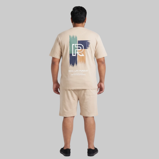 Men's Cream Beige Real Life Pursuit Graphic Interlock T-Shirt and Shorts Co-Ord Set with front chest print and large back graphic.
