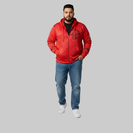 Man wearing a red hoodie with black text and blue jeans on a gray background