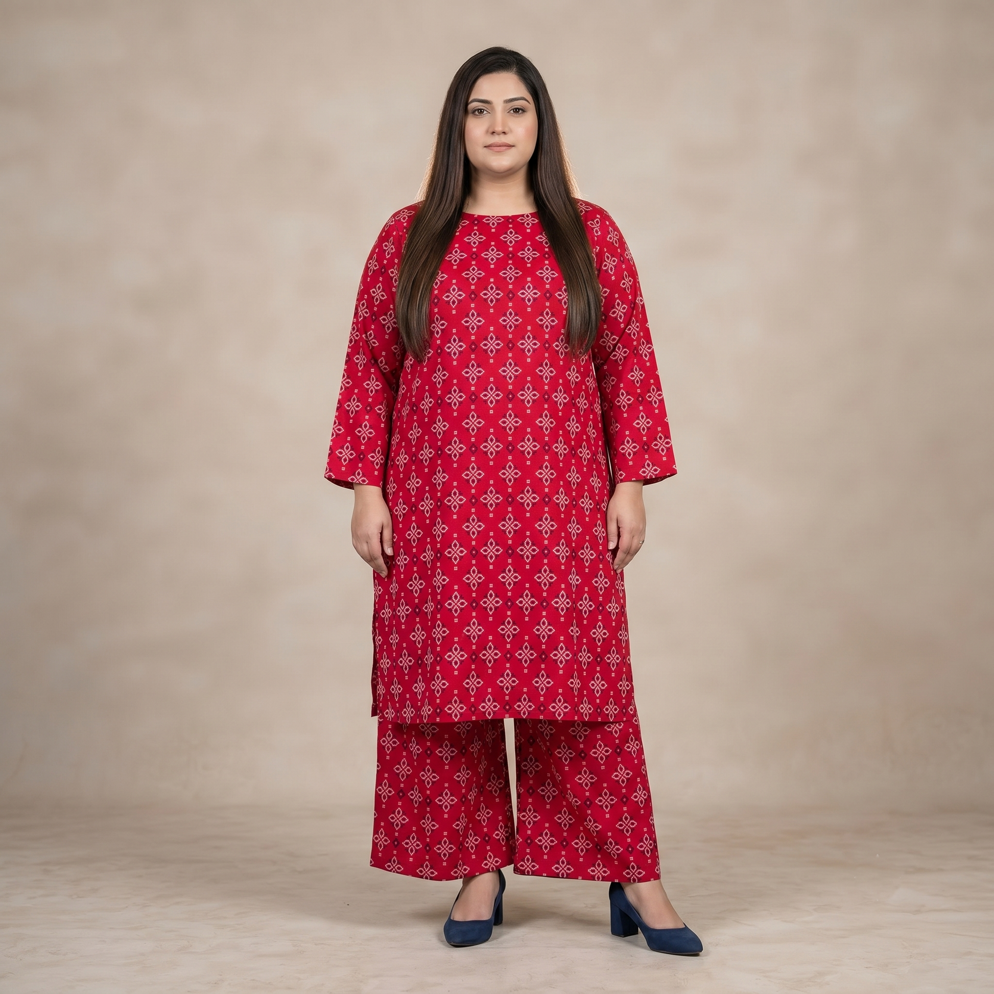 Woman wearing a red patterned outfit against a beige background