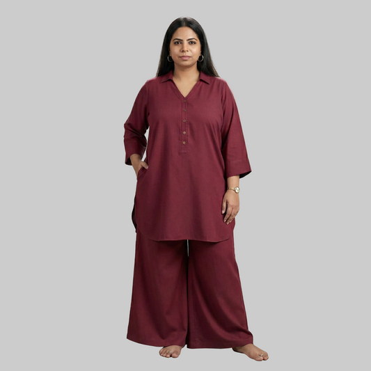 Woman wearing a maroon outfit against a neutral background