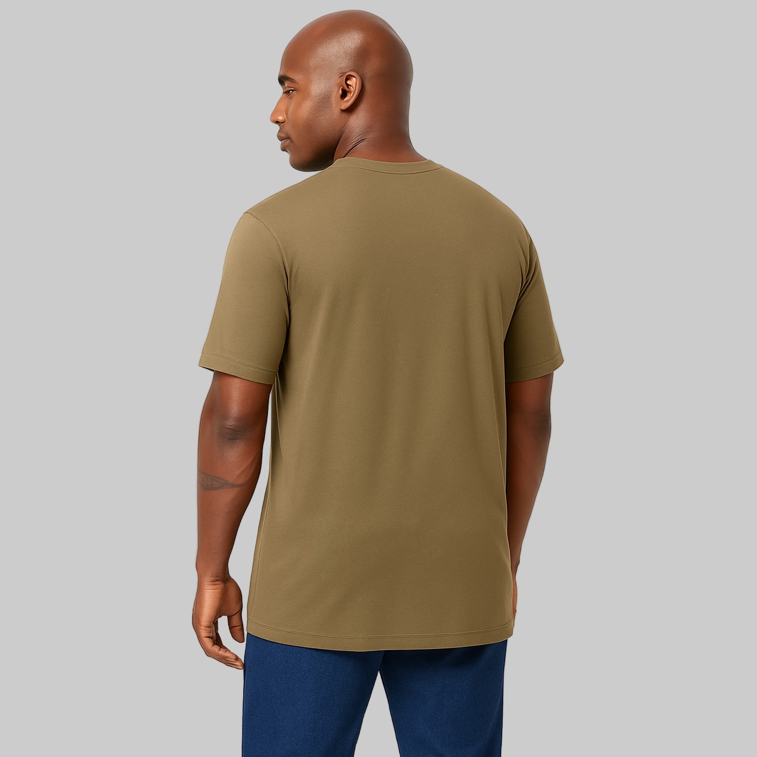 Plus-size Pakistani male model wearing dark khaki heavyweight crewneck T-shirt on a studio background, relaxed fit.