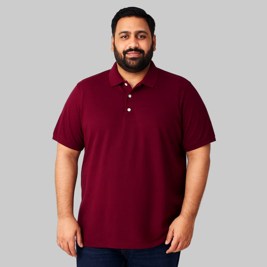 Plus-size Pakistani male model wearing dark magenta piqué polo shirt with chest pocket on a clean studio background.