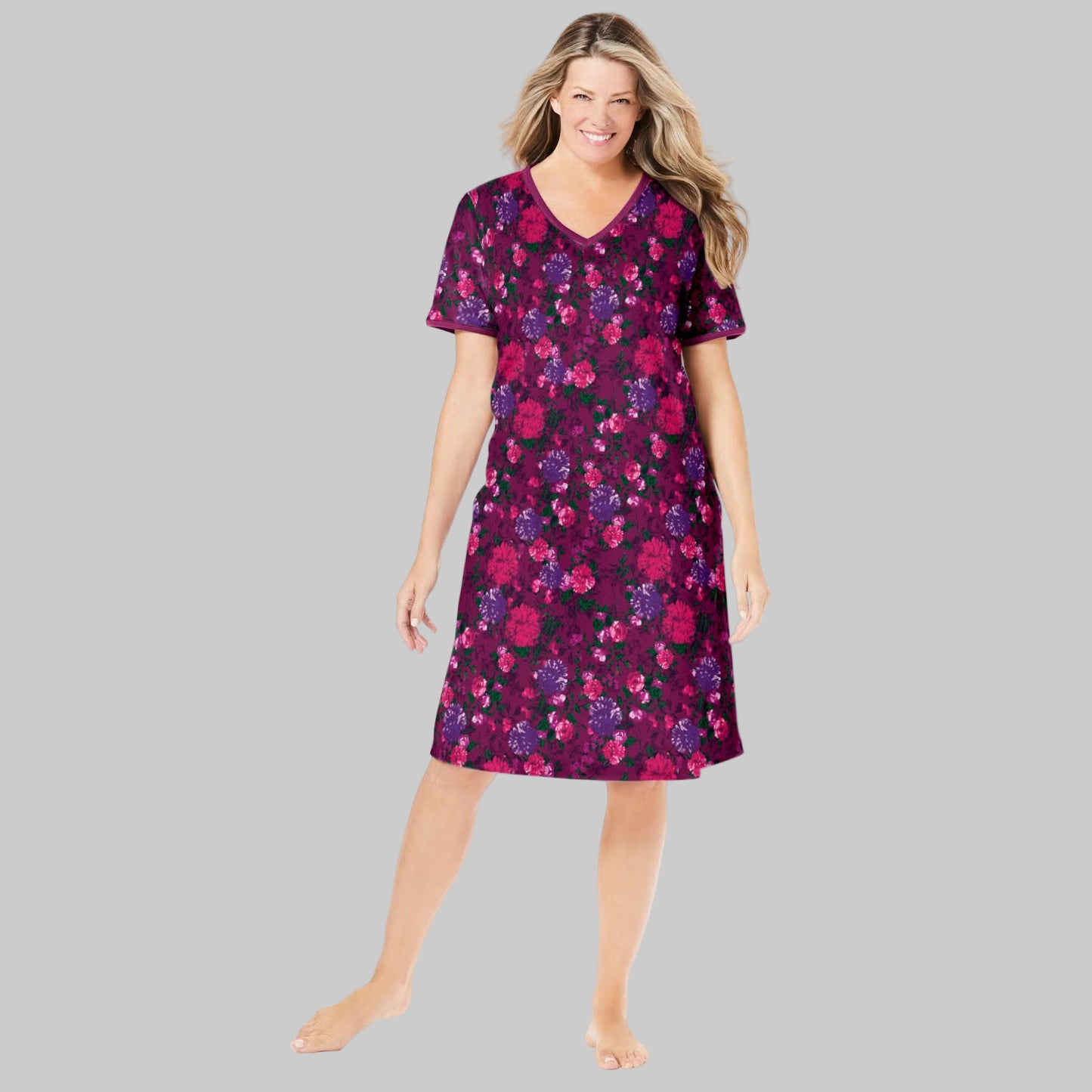 Plus-size woman wearing a deep claret floral short T-shirt lounger with V-neck, short sleeves, and side pockets, on a white background.