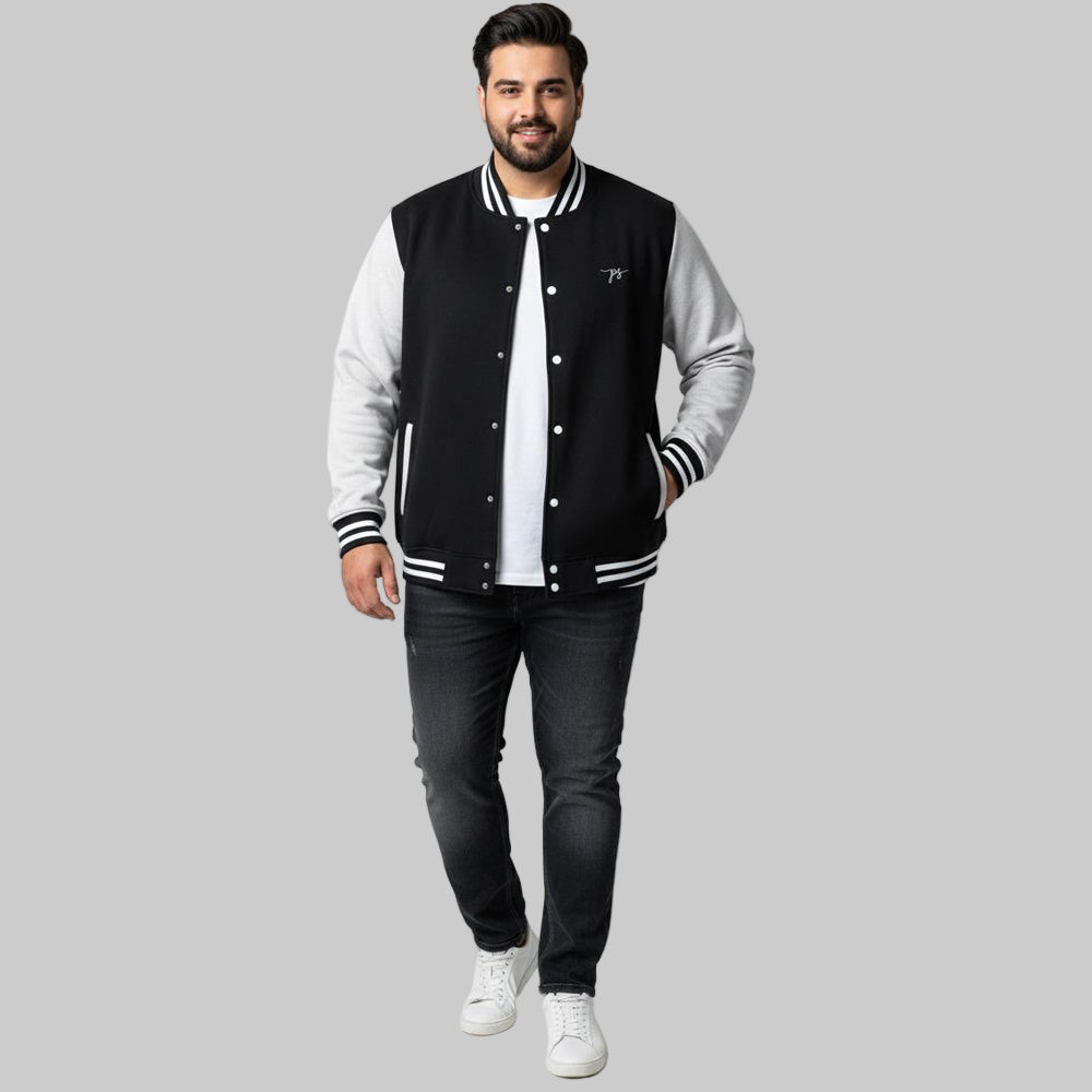 Plus-size male and female models wearing black and grey dual-tone varsity fleece jackets with striped cuffs and collars, photographed in studio.