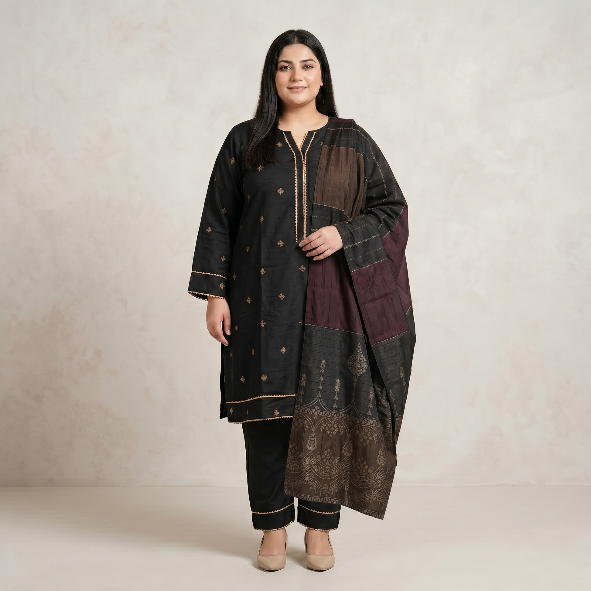 Woman wearing a traditional outfit with a long jacket and pants on a plain background