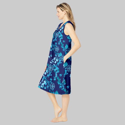 Plus-size woman wearing an evening blue sleeveless short lounger with a peony floral print, side pockets, and V-neck, on a white background.