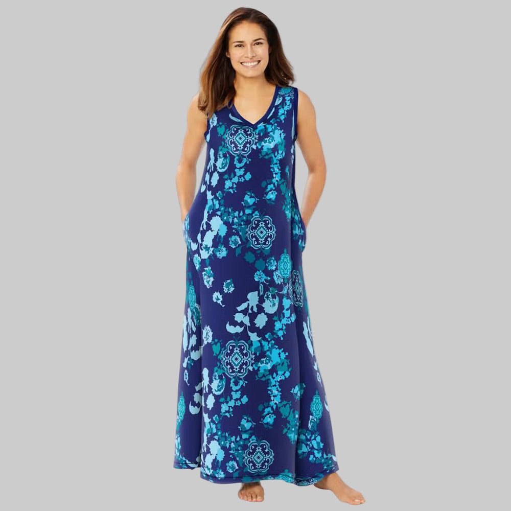 Plus-size woman wearing an evening blue sleeveless V-neck lounger with peony floral print, side pockets, and side slits on a white background.