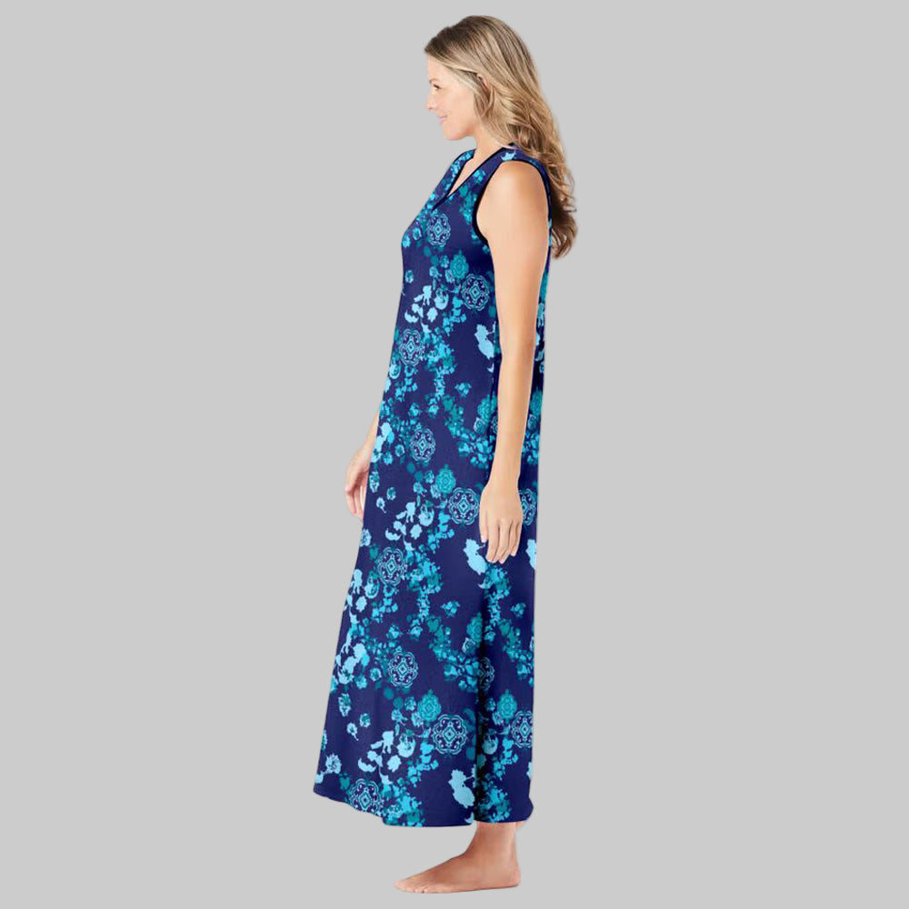 Plus-size woman wearing an evening blue sleeveless V-neck lounger with peony floral print, side pockets, and side slits on a white background.