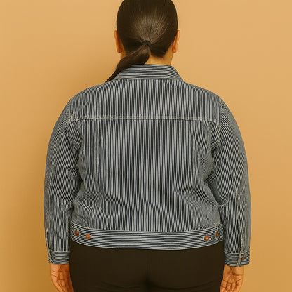 Plus-size woman wearing a vintage blue striped jean jacket with chest pockets and button closure