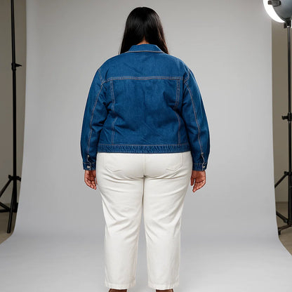 Plus-size woman wearing indigo denim jacket with oversized utility pockets and button front