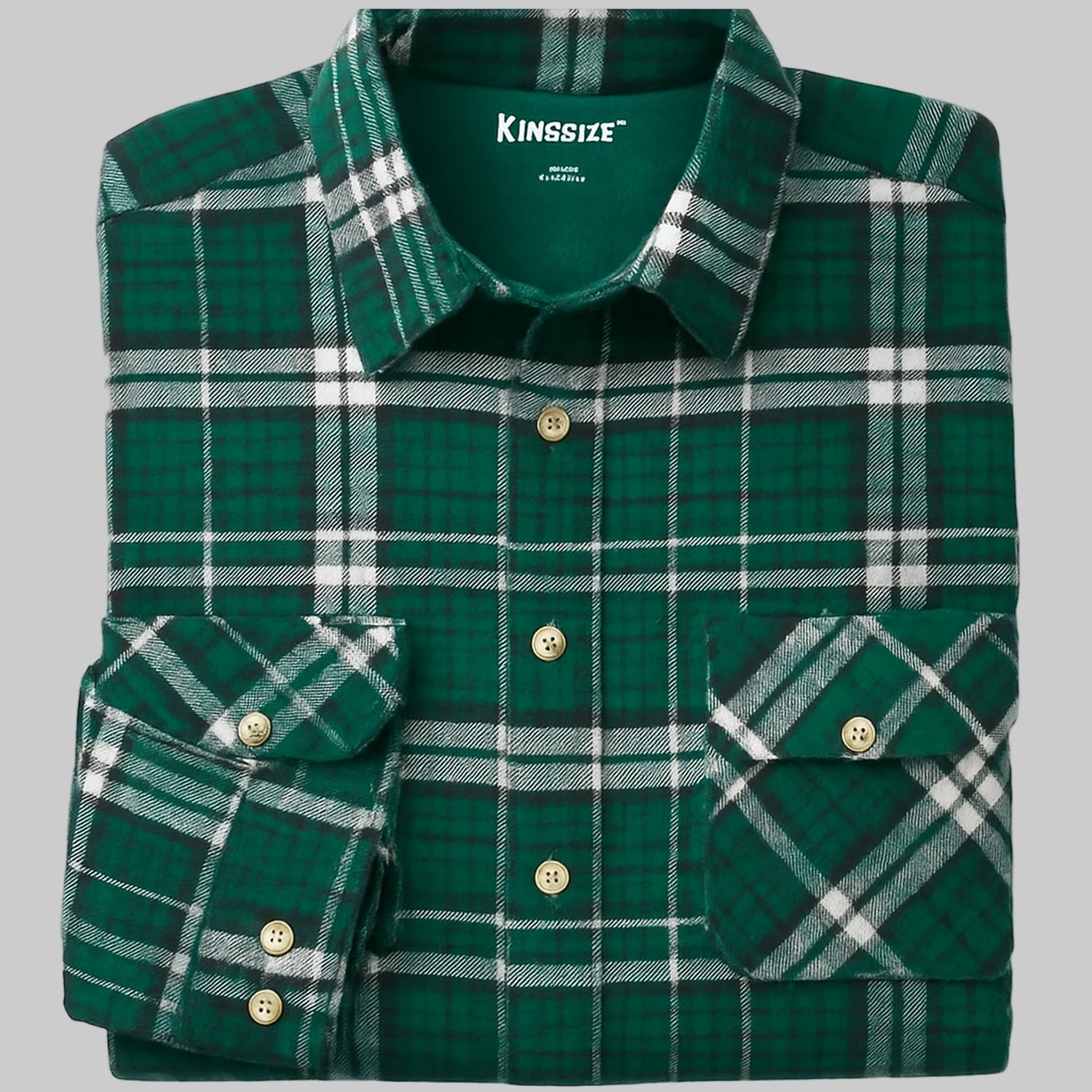 Folded forest green plaid flannel shirt with button-flap chest pockets, long sleeves, and soft cotton fabric — cozy and classic men’s winter shirt.