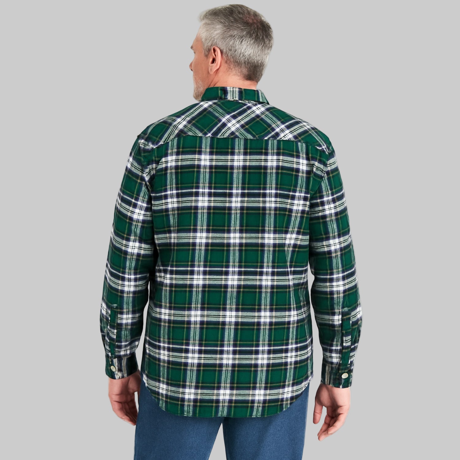 Folded forest green plaid flannel shirt with button-flap chest pockets, long sleeves, and soft cotton fabric — cozy and classic men’s winter shirt.