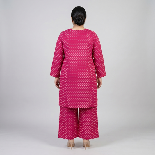 Woman wearing a pink patterned outfit on a gray background