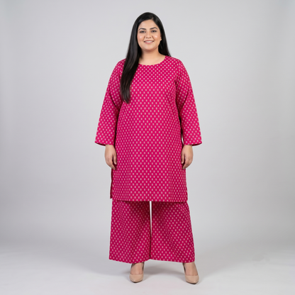 Woman wearing a pink polka dot kurta with palazzo pants on a white background