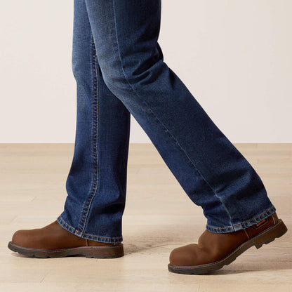 Plus-size male model wearing Galveston Relaxed Boot Cut Jeans in dark denim, showing relaxed fit, classic boot-cut leg opening, and durable workwear details.