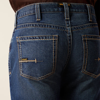 Plus-size male model wearing Galveston Relaxed Boot Cut Jeans in dark denim, showing relaxed fit, classic boot-cut leg opening, and durable workwear details.