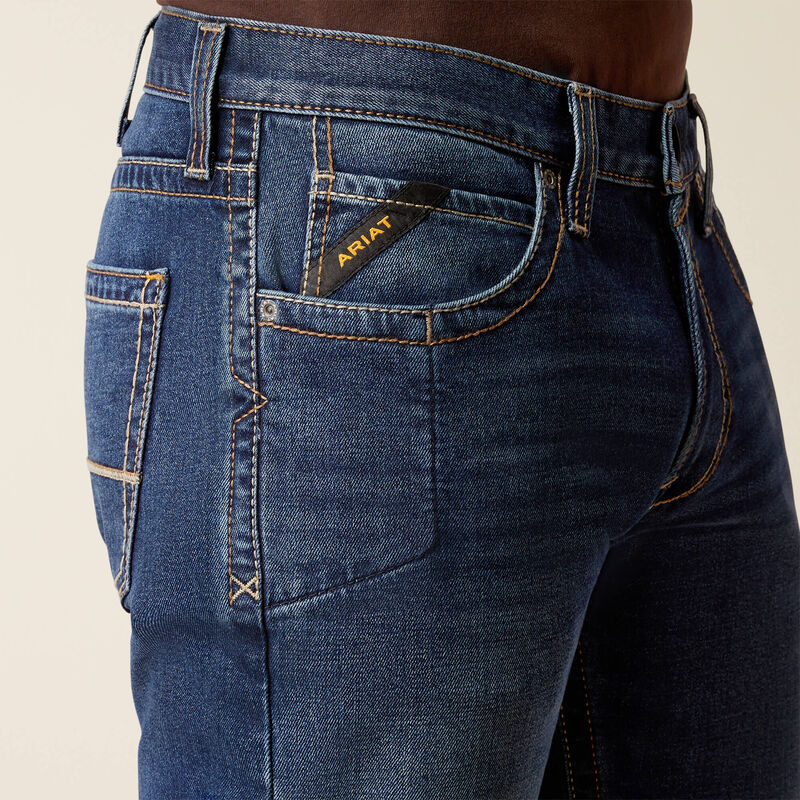 Plus-size male model wearing Galveston Relaxed Boot Cut Jeans in dark denim, showing relaxed fit, classic boot-cut leg opening, and durable workwear details.