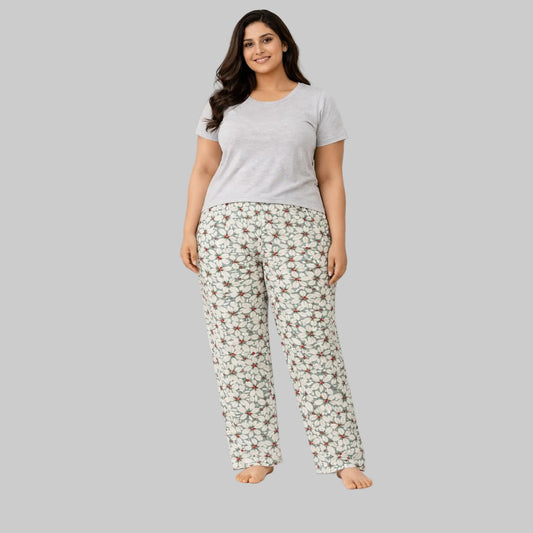 Grey and white leaf and berry flannel pajama pants worn by model