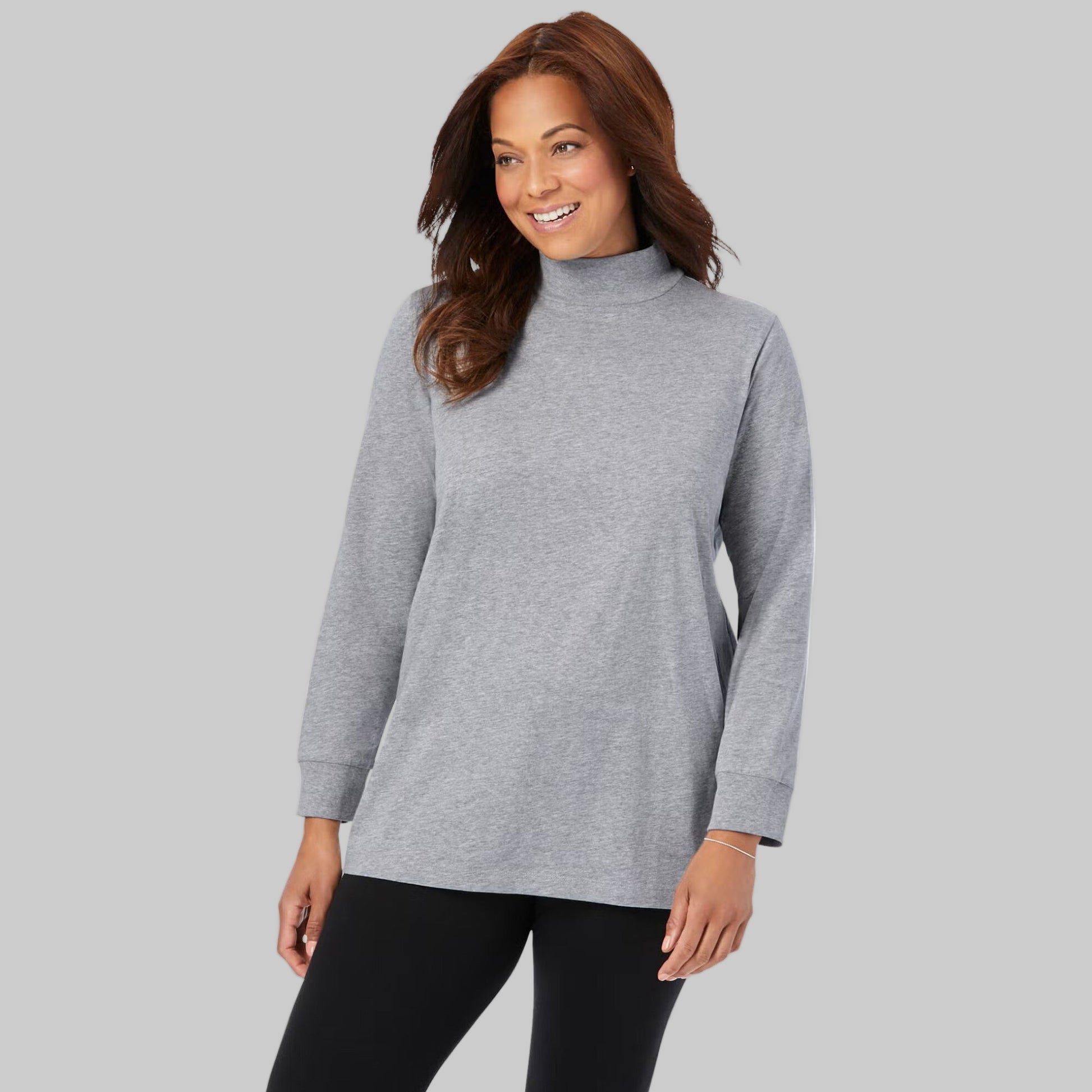 Plus-size woman wearing a heather grey long-sleeve mockneck tee with a relaxed fit, displayed on a white studio background.