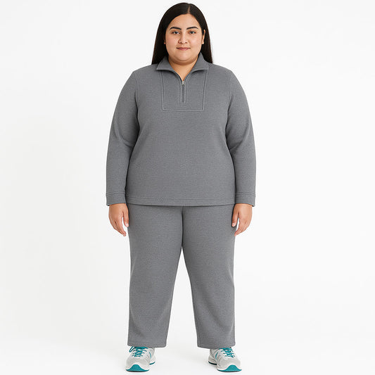 Plus size woman wearing teal French Terry knit pajama set with zip-up top and matching pants