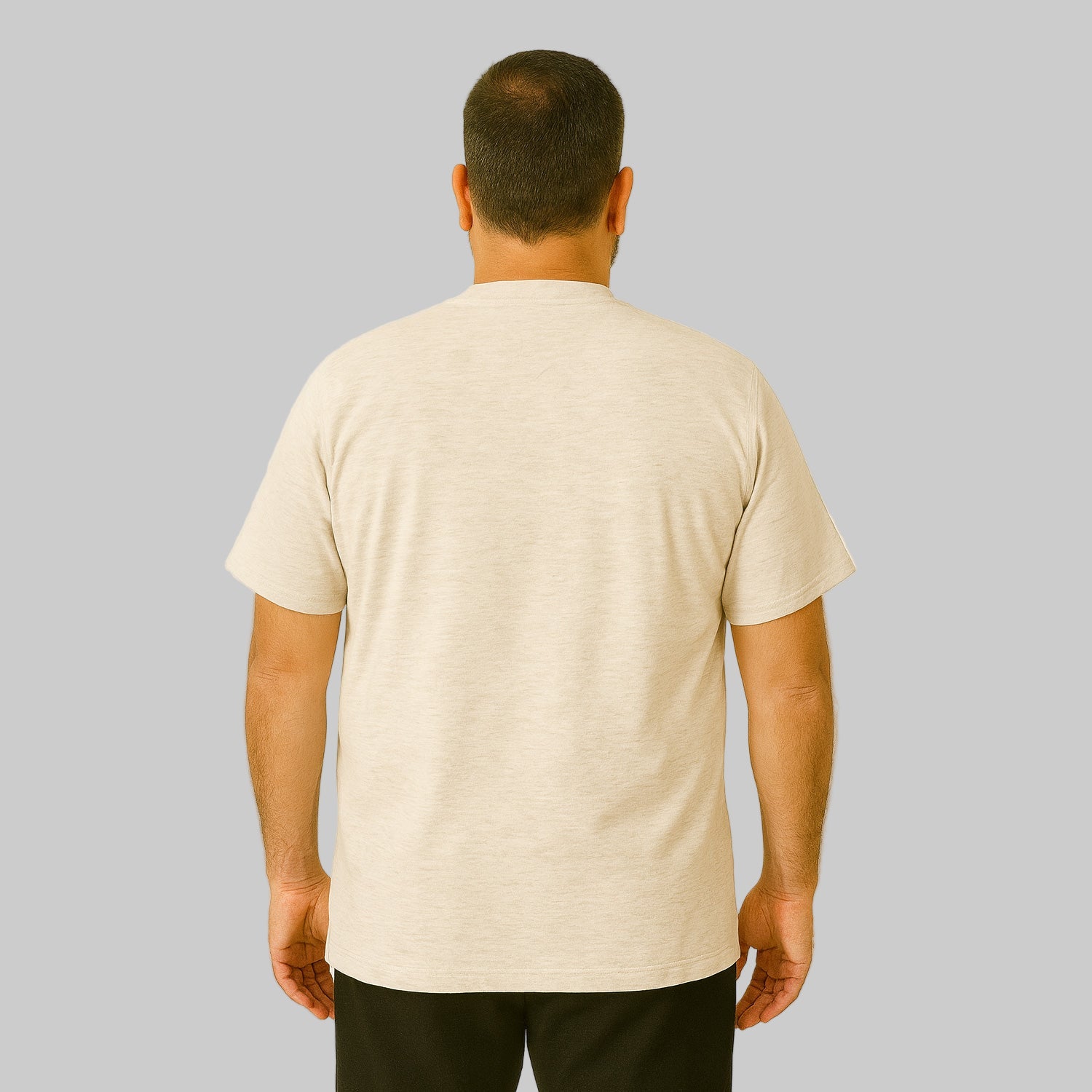 Plus-size Pakistani male model wearing heather oatmeal short-sleeve Henley shirt on a studio background, relaxed fit.