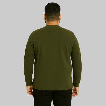 Plus-size Pakistani male model wearing heather olive waffle-knit thermal Henley shirt on a clean studio background, long sleeves, relaxed fit.