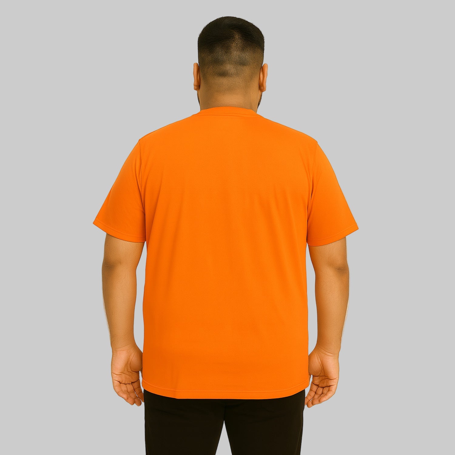 Plus-size Pakistani male model wearing heather orange crewneck pocket T-shirt on a clean studio background.