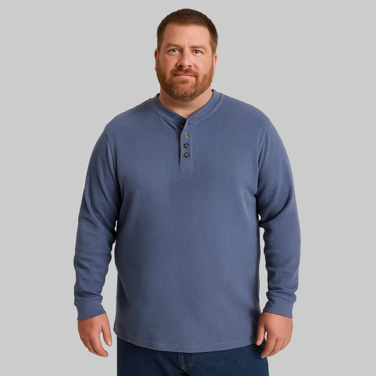 Plus-size Pakistani male model wearing heather slate blue waffle-knit thermal Henley tee on a light studio background, long sleeves, relaxed fit.