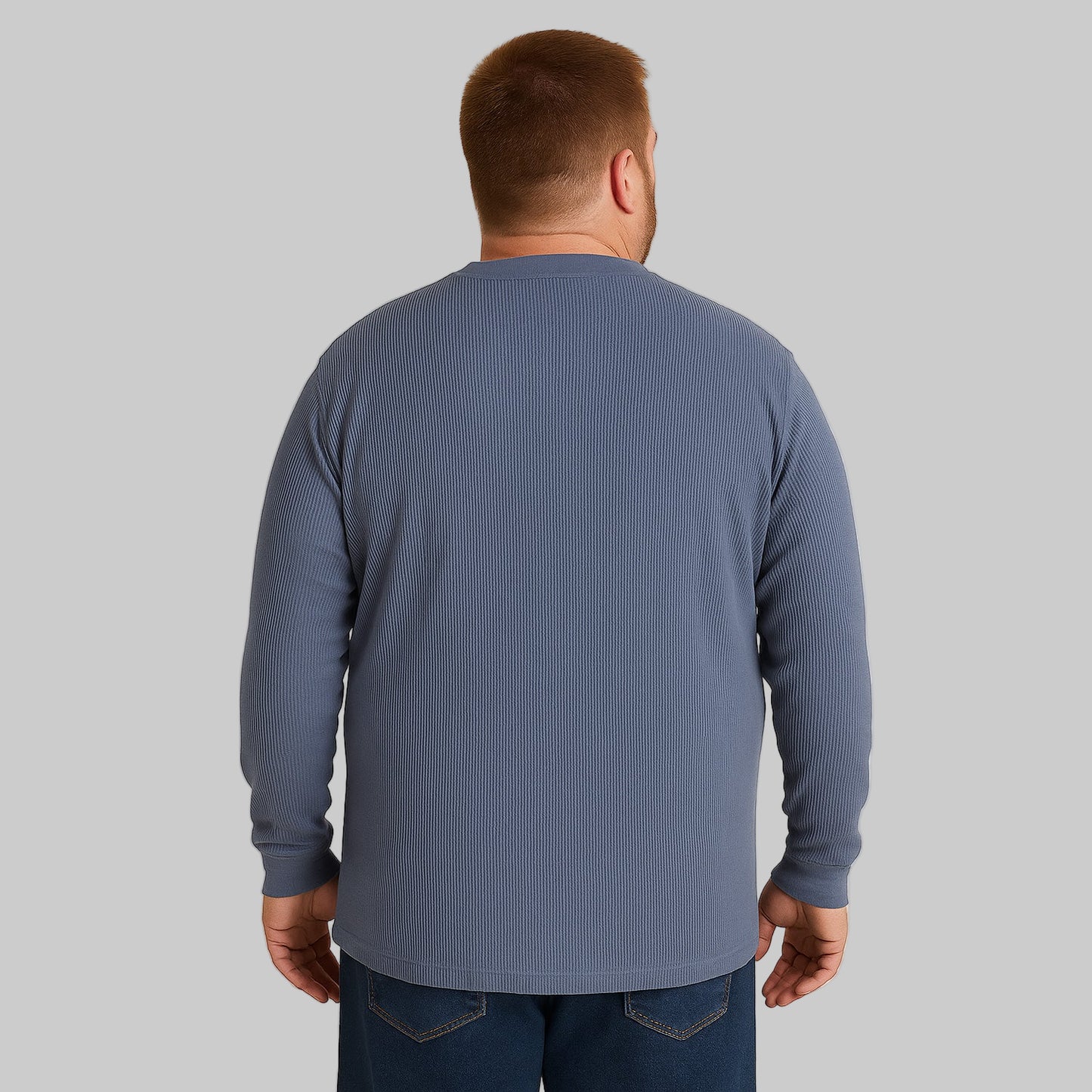 Plus-size Pakistani male model wearing heather slate blue waffle-knit thermal Henley tee on a light studio background, long sleeves, relaxed fit.