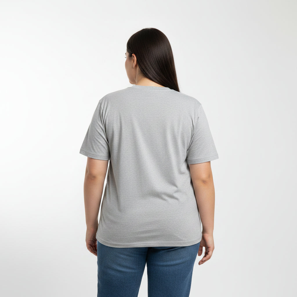 Woman wearing a gray t-shirt and blue jeans on a white background