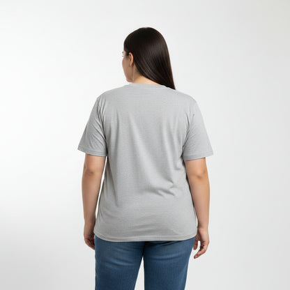 Woman wearing a gray t-shirt and blue jeans on a white background
