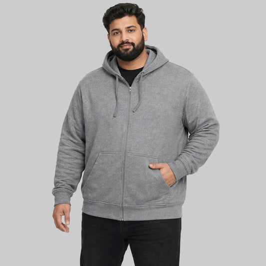 Plus-size male model wearing a heather grey zip-up hoodie with a relaxed fit on a white background