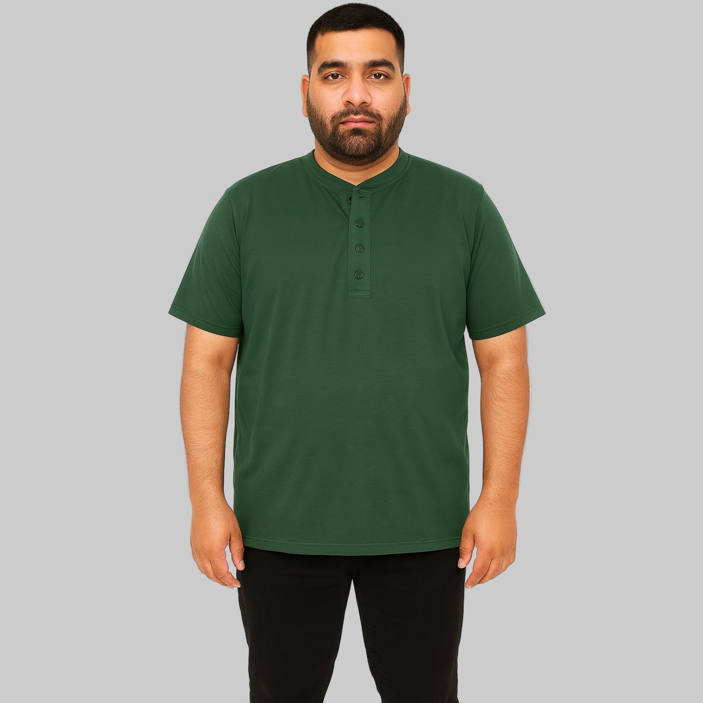 Plus-size male model wearing hunter green Henley T-shirt with 4-button placket, front view, studio background.