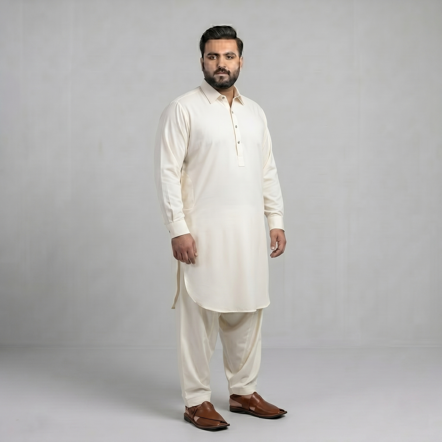 Man wearing a white kurta with brown shoes on a gray background