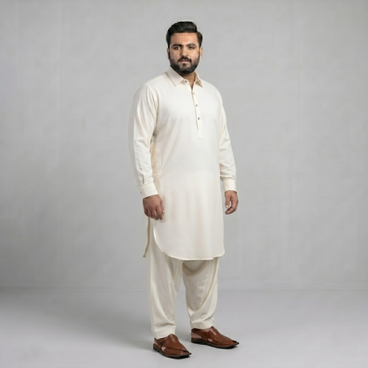 Man wearing a white kurta with brown shoes on a gray background
