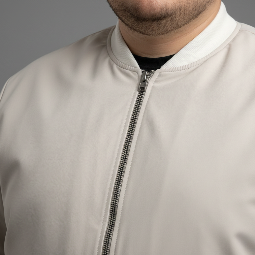 Ivory plus size bomber jacket with front zip closure and ribbed cuffs on a clean background.