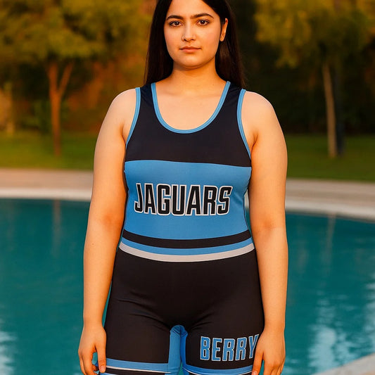 Pakistani woman wearing Jaguars Berry one-piece swimsuit with sporty graphics, sleeveless and modest short-leg swimwear in black and blue