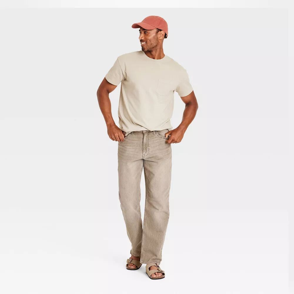 Plus-size male model wearing Khaki Relaxed Fit Jeans, mid-rise relaxed leg, classic 5-pocket design, stretch denim texture, studio front view.