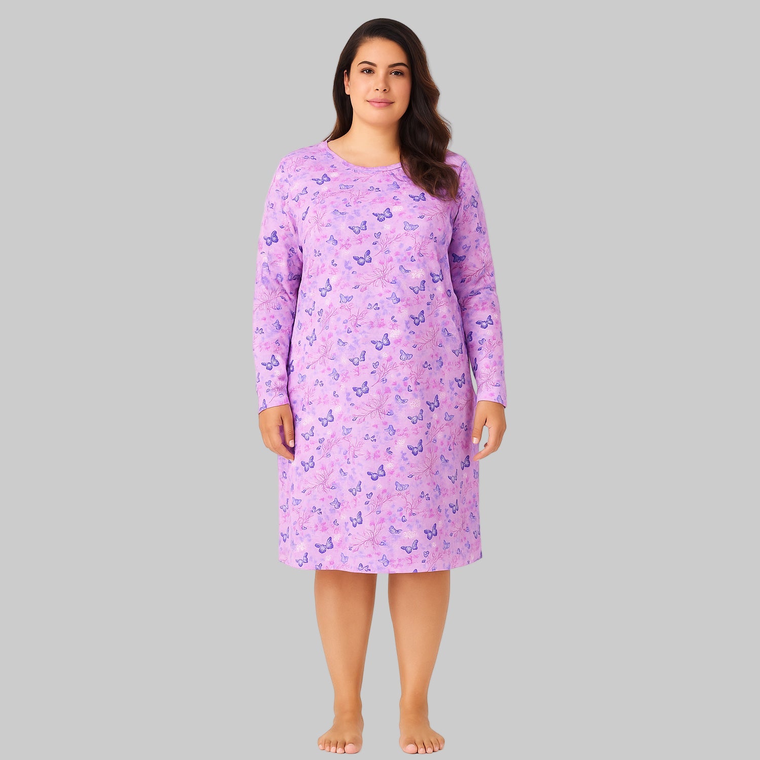 Plus-size woman wearing a lavender long-sleeve cotton sleepshirt with a relaxed fit, photographed on a clean white background.