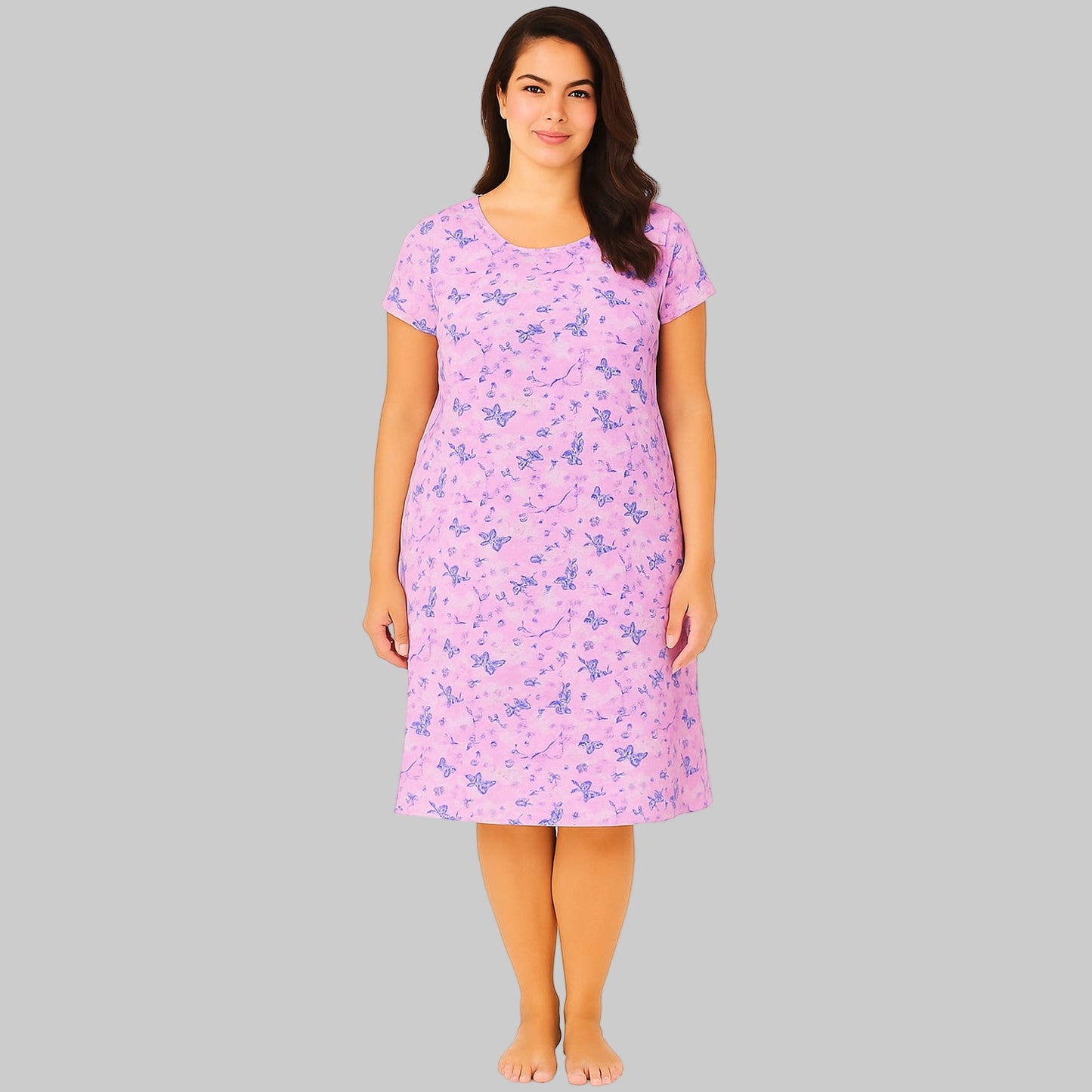 Plus-size woman wearing a lavender short sleeve cotton sleepshirt with relaxed fit, shown on a clean white studio background.