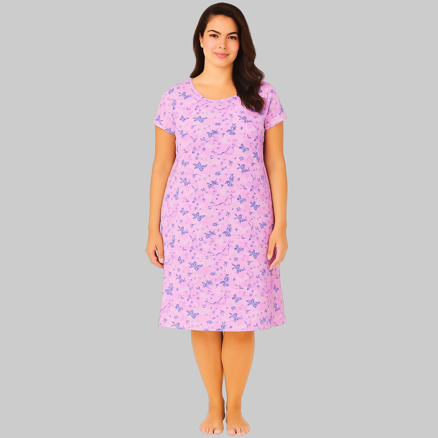Plus-size woman wearing a lavender short sleeve cotton sleepshirt with relaxed fit, shown on a clean white studio background.