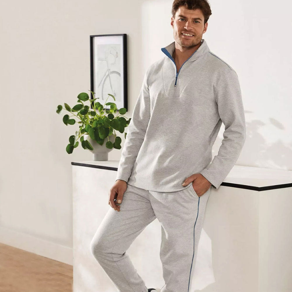Light grey men's fleece tracksuit with half-zip collar, blue contrast details, and jogger-style bottoms.