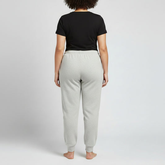 Light heather grey jersey jogger pants with a relaxed fit, elastic waistband, adjustable drawstring, and ribbed ankle cuffs, shown in a clean studio view for everyday comfort and casual wear.