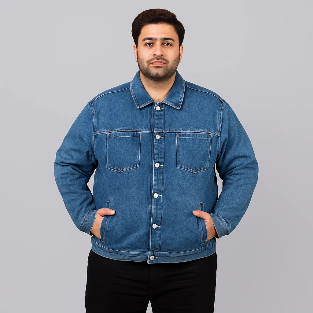 Plus-size man wearing mid-wash utility denim jacket with chest patch pockets and side hand pockets