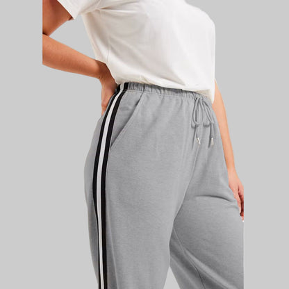 Medium Heather Grey French Terry Joggers with side stripe detailing, drawstring waist, and ribbed cuffs — slim-fit plus size lounge joggers for women.